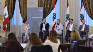 People sitting at a panel at a conference