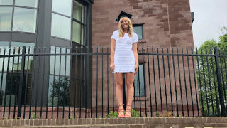 Paige Anderson stands outside on Seton Hall signage