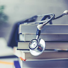A Stethoscope Draped Over A Stack of Books