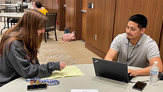 Photo2 3.28.23 Photo of customer taking advantage of the complimentary tax prep services offered on campus in March by VITA program volunteers.