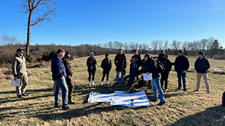 Photo of CDT Thomas Kachler explaining fire and maneuver to Seton Hall’s Pirate Battalion