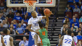 Romaro Gill on a basketball court blocking a shot