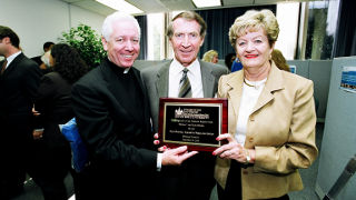 Ruth and Thomas Sharkey receiving a plaque at the dedication of the Ruth Sharkey Academic Resource Center. 