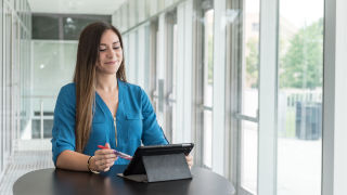 SHU female Graduate student working on a laptop