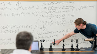 Physics Lecture in front of whiteboard 