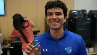Student-athlete displays his finished keychain.