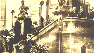 Seminarians, college students, and professors on front steps 1880s. Seminarians, college students, professors on the front steps of the seminary building. - AAN