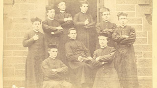 1870s. Seminarians on the chapel steps; unidentified professor in middle. – AAN