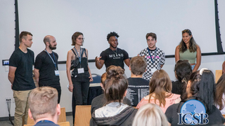 Seton Hall University students pitch a business idea with teammates a the ICSB Academy Cup.Seton Hall University students Peter Colon and Kyara Syed are recognized with their teammates for winning the Academy Cup business competition