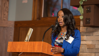 Image of Shea Richardson.CEHS Interim Dean, Joseph Martinelli, Ed.D., addressing the audience of alumni, students, staff and friends of the college. Richardson accepts the Hanbury Alumni Mission Award and thanks her colleagues, mentors, past professors and her family for their support.