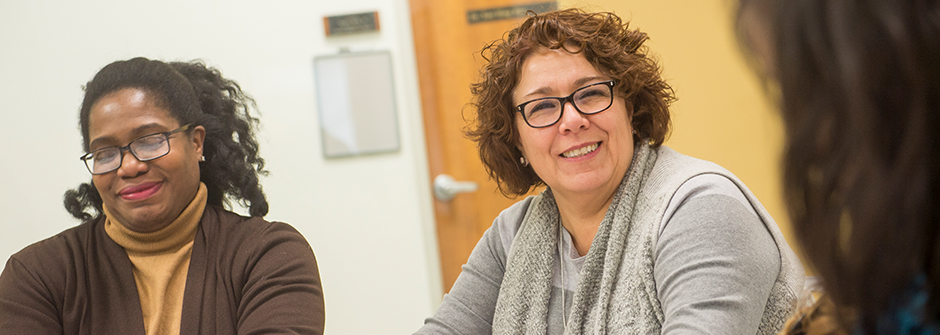 Social Work Content Header image of faculty around a desk