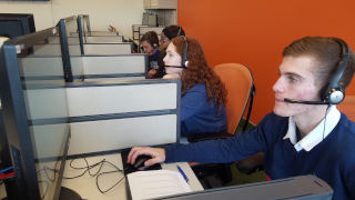 Students sitting at computers for sports polling