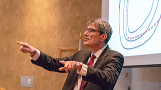 Sir Steven Cowley presenting a lecture. 