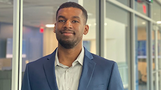 Photo of junior undergraduate student Malik Redwood, who presented a live Python coding workshop at the National Research Data Access and Preservation conference in March.