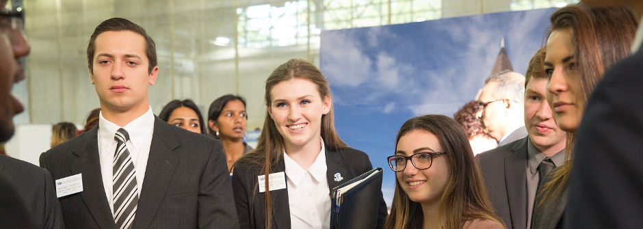 Seton Hall Students speak with an Employeer at Career Fair