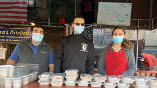 headshot image of Chris Lowneystudents standing and posing while giving out food