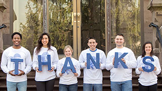 Photo of students holding letters to spell out 