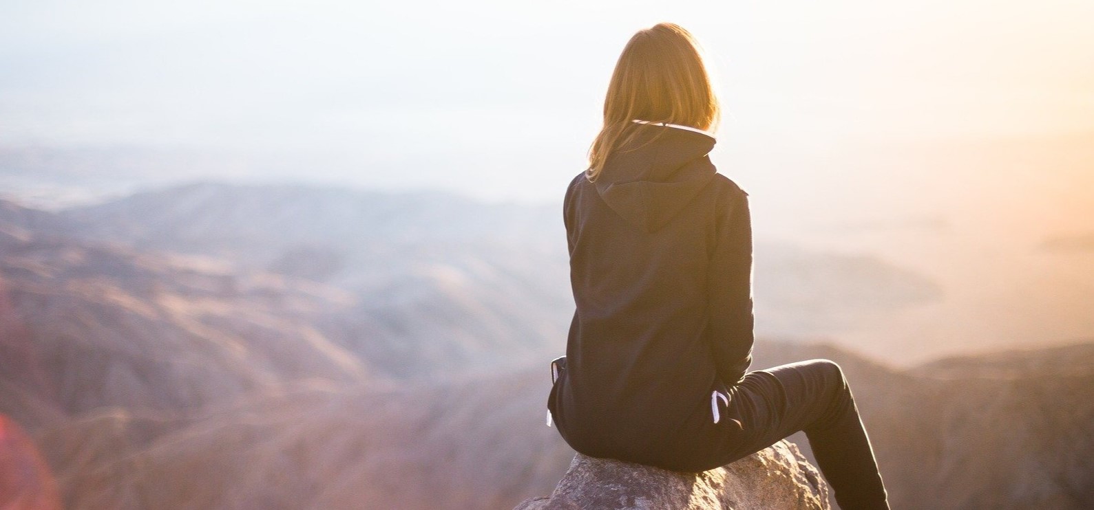 Student looking off into distance from mountain