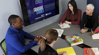Professor Robinson and graduate students working on a project.