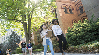 students walking along sidewalk path on SHU campus