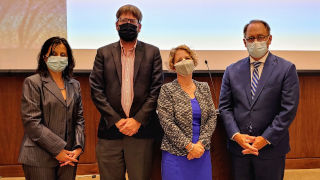 Amy Hunter standing with President Nyre and other faculty members