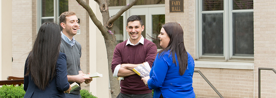 Arts and Sciences students talking on campus near Fahy Hall.