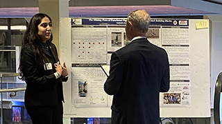 Student and judge at poster competition