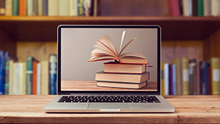 Image of books on a laptop