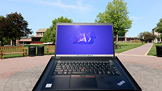 A photo of a laptop in front of The Green at Seton Hall