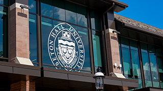 A photo of the front window in the University Center, featuring the Seton Hall seal