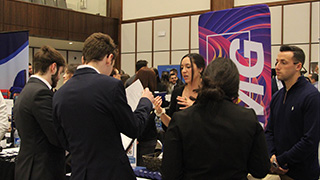 Students interacting with professionals from KPMG at the 2023 Career Expo.