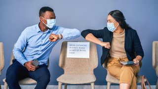 People wearing masks in a waiting room for job interview. 