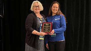 Chair of NAFSA giving Johanna the service award