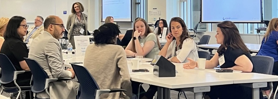 Professionals sitting around a conference table during a meeting.