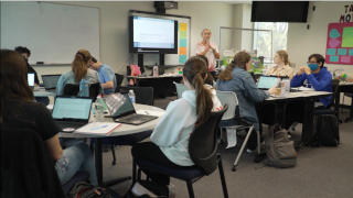 Students in the classroom with their teacher.