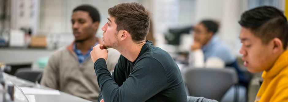 Students listening in a classroom.