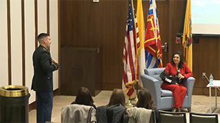 Colonel Chalas speaking with another military member at an event for the Latino Institute. 