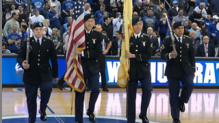 Color Guard presenting the flag during a basketball game. 