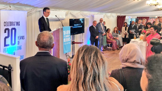 Andrew Murrison, Minister for the Middle East speaking in front of a crowd at a podium discussing a plan to help resolve tensions in Yemen.  