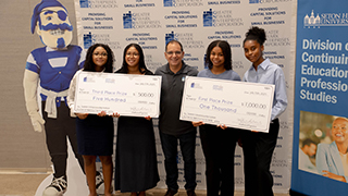 continuing-education participants holding a big check