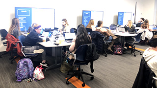 A photo of students learning about the DataLab