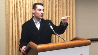 Student speaking at a podium participating in the Semester in Washington, D.C. 