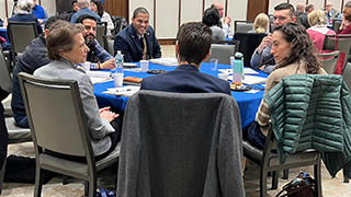 Guests sharing a discussion at a table.