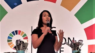 Earlene Cruz speaking at a conference. 