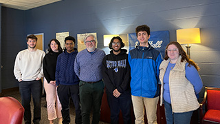 Ed Eigerman pictured with students from the College of Arts and Sciences.