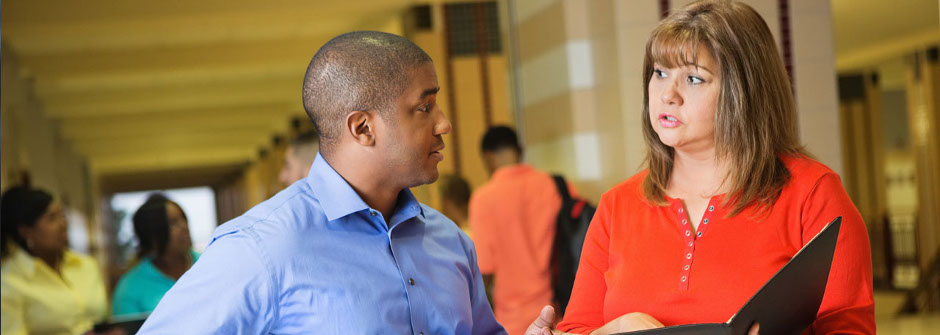 School leaders talking in school hallway. 