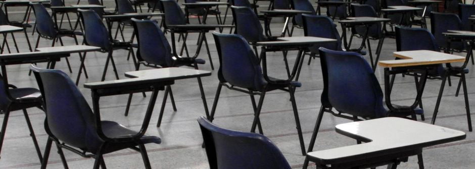 Empty chairs in an exam hall.