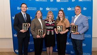 Stillman School of Business award winners, Sina Shokoohyar, Elizabeth McCrea, Danielle Zanzalari, and Gregory Licciardi flank Dean Joyce Strawser.