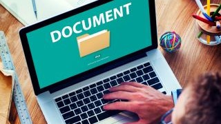 Person sitting in front of their laptop which is displaying a document icon.