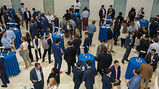 Students speaking with finance professionals.